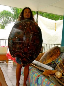Linc demonstrating how large the sea turtles are … it takes a few men to pull them out of the water. 