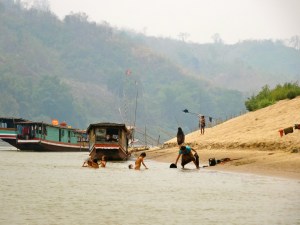 Kids playing by the shores of the Mekong. 