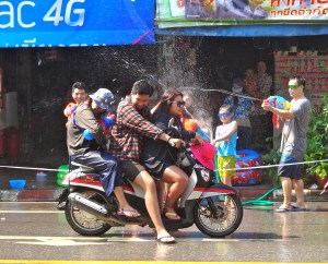 Motorcycle water battle.  Notice that the third person on the back of that motorcycle has a water gun.  